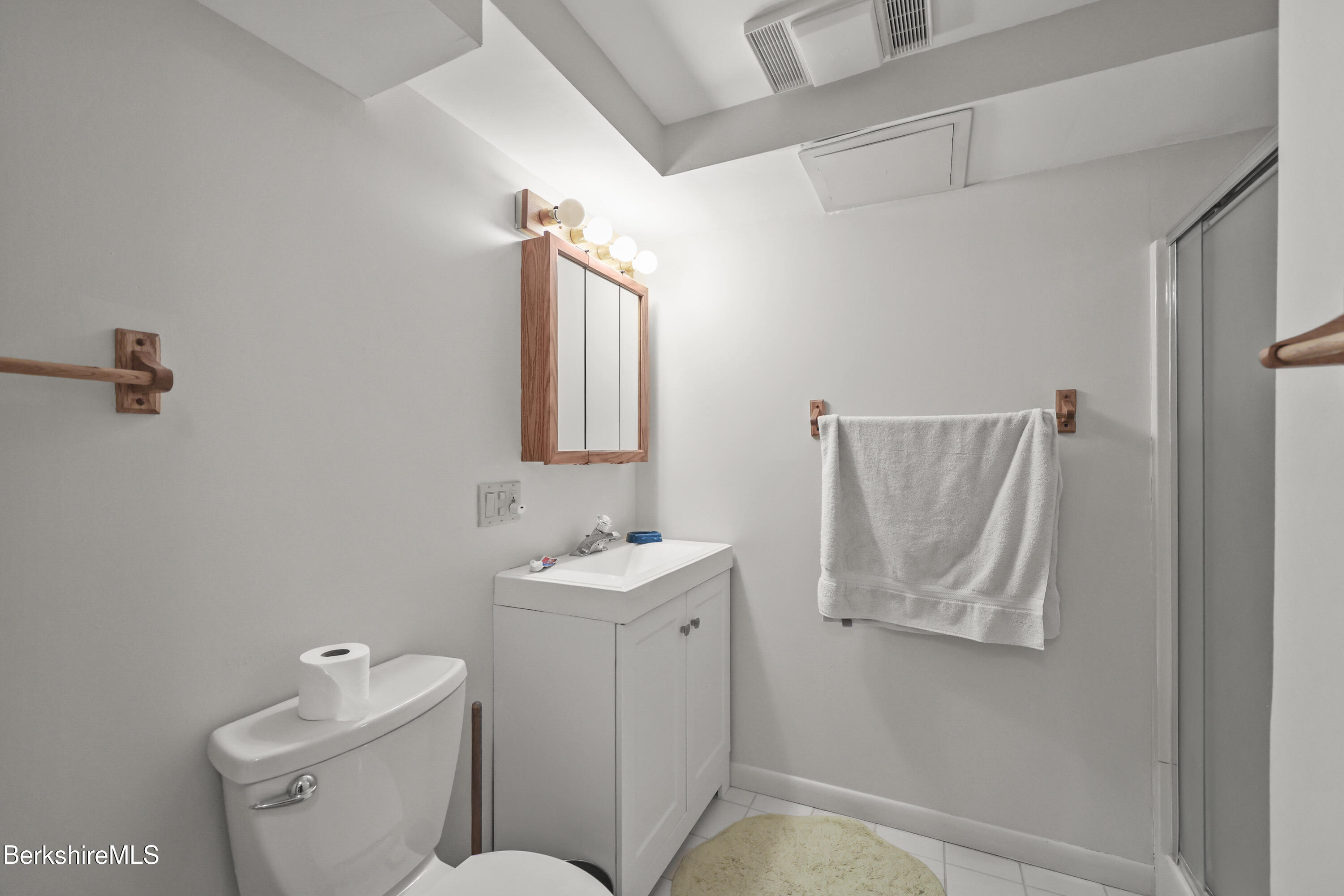 7 Rolling Hills, Unit 71 Lenox, MA 01240 - Photo 24 of 47 a bathroom with a toilet sink and mirror