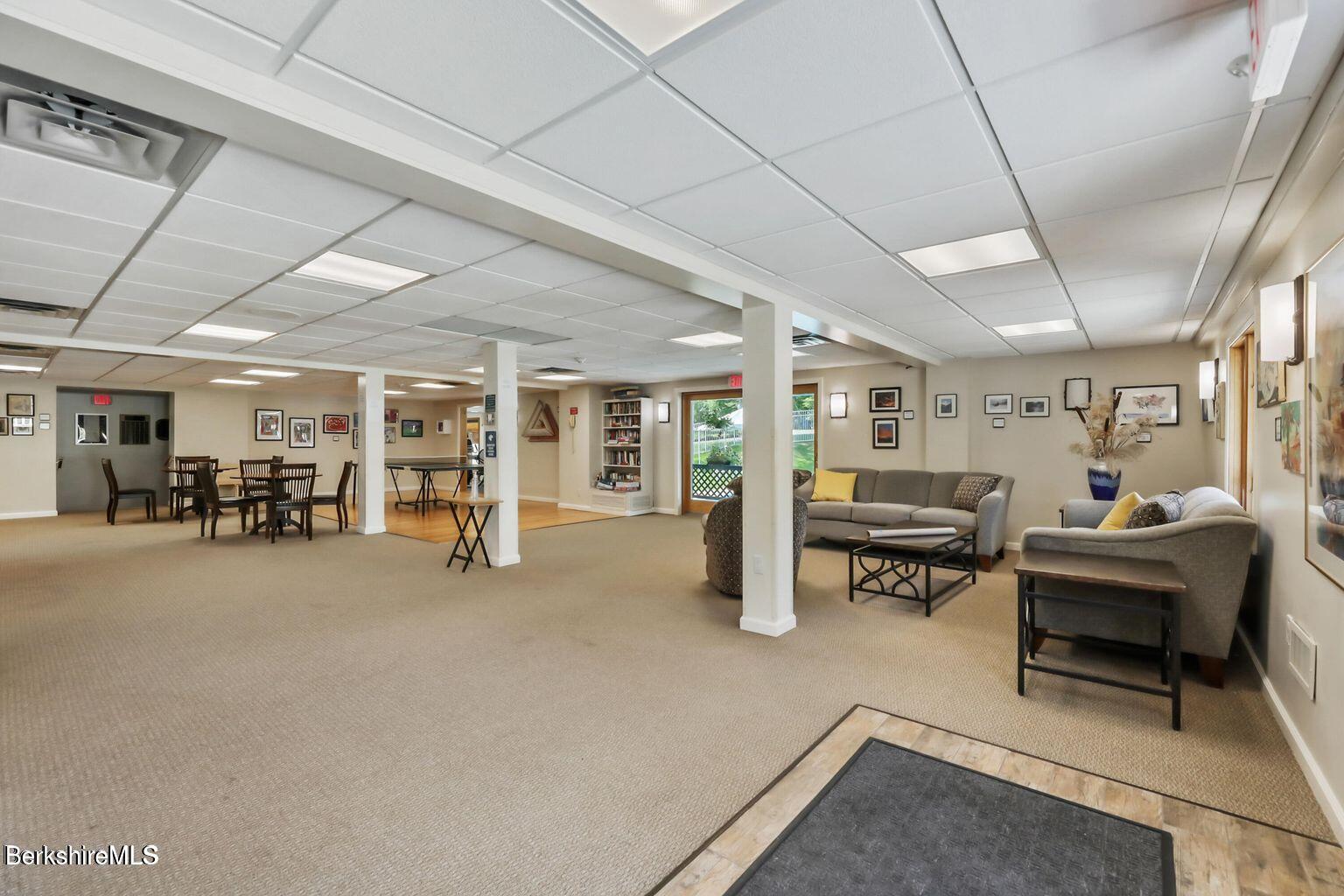 7 Rolling Hills, Unit 71 Lenox, MA 01240 - Photo 37 of 47 a view of a livingroom with furniture and a garage
