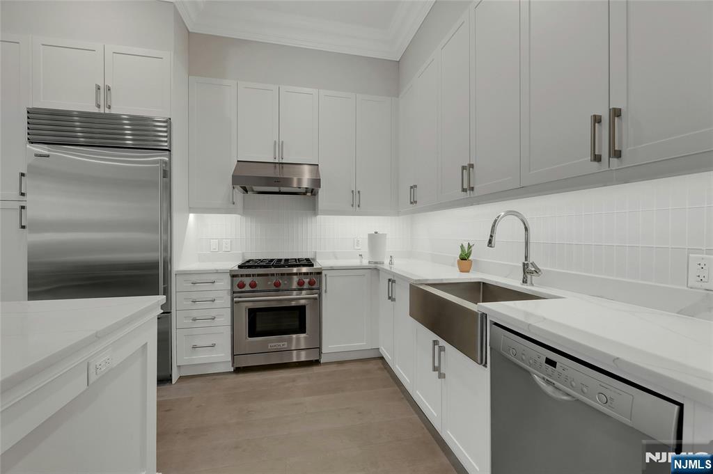 3 Somerset Lane, Unit 109 Edgewater, NJ 07020 - Photo 11 of 50 a kitchen with cabinets stainless steel appliances and a sink