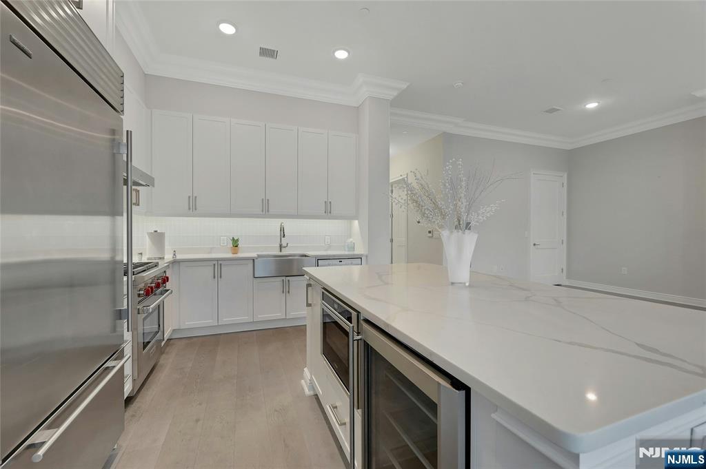 3 Somerset Lane, Unit 109 Edgewater, NJ 07020 - Photo 13 of 50 a kitchen with a sink appliances and cabinets