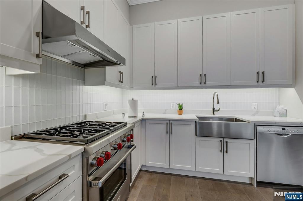 3 Somerset Lane, Unit 109 Edgewater, NJ 07020 - Photo 14 of 50 a kitchen with cabinets appliances and a sink