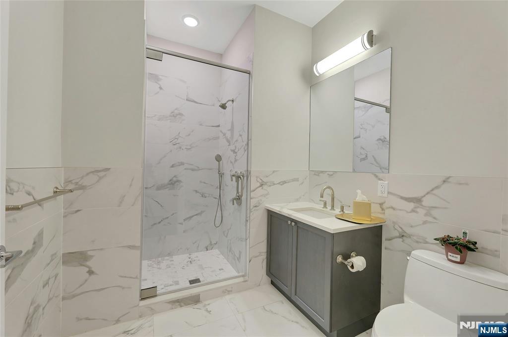3 Somerset Lane, Unit 109 Edgewater, NJ 07020 - Photo 15 of 50 a bathroom with a sink toilet and shower