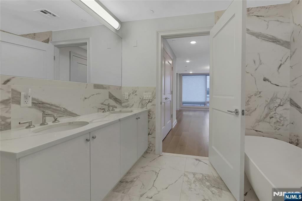 3 Somerset Lane, Unit 109 Edgewater, NJ 07020 - Photo 23 of 50 a bathroom with a bathtub and a sink