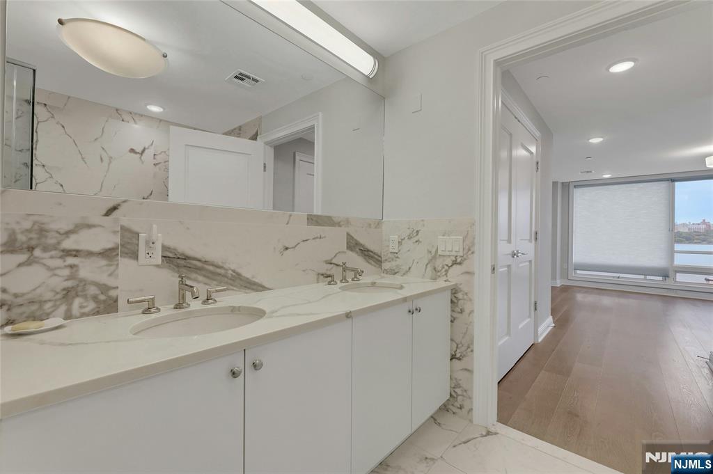 3 Somerset Lane, Unit 109 Edgewater, NJ 07020 - Photo 25 of 50 a bathroom with a sink and a mirror
