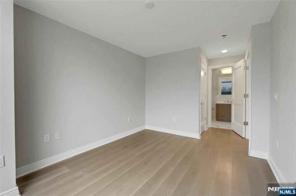 3 Somerset Lane, Unit 109 Edgewater, NJ 07020 - Photo 28 of 50 a view of a big room with wooden floor and windows