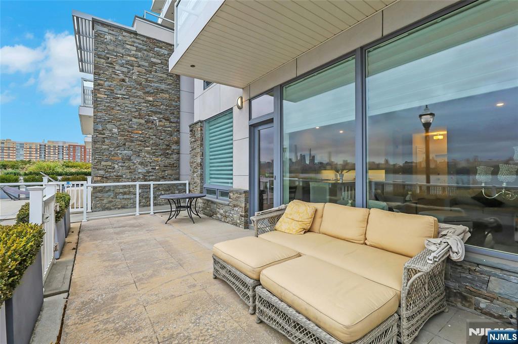 3 Somerset Lane, Unit 109 Edgewater, NJ 07020 - Photo 38 of 50 a roof deck with couches and potted plants