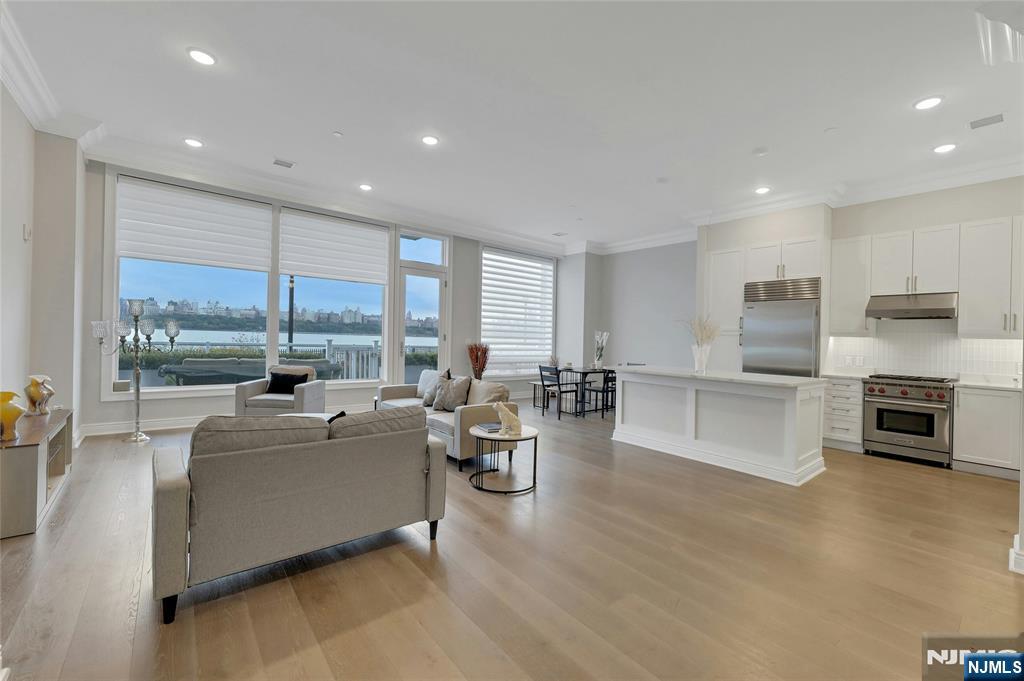 3 Somerset Lane, Unit 109 Edgewater, NJ 07020 - Photo 4 of 50 a living room with fireplace furniture and a large window