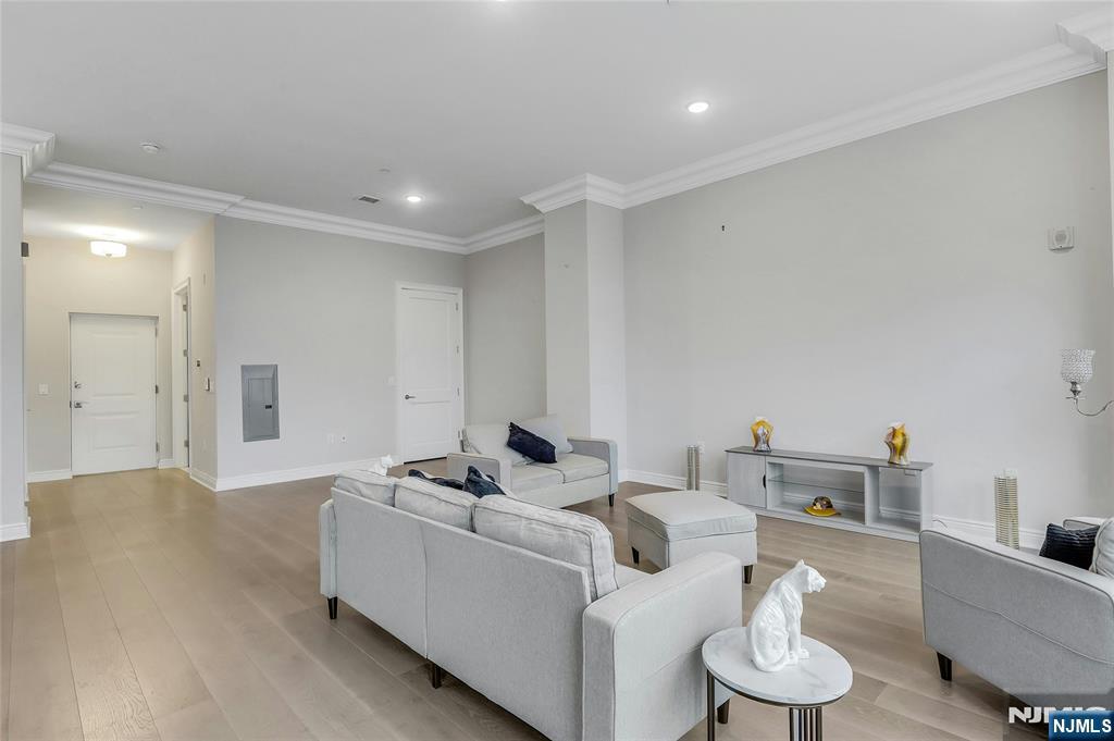 3 Somerset Lane, Unit 109 Edgewater, NJ 07020 - Photo 6 of 50 a living room with furniture and a wooden floor