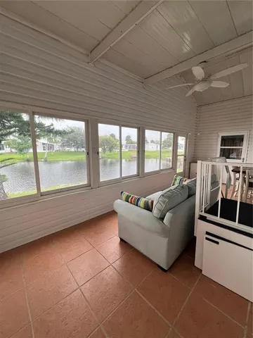 a living room with furniture and a floor to ceiling window