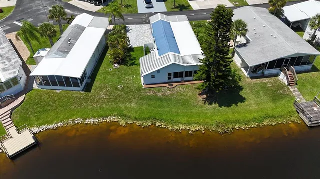 an aerial view of a house with garden space and street view
