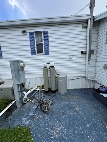 a view of a house with a yard and sitting area