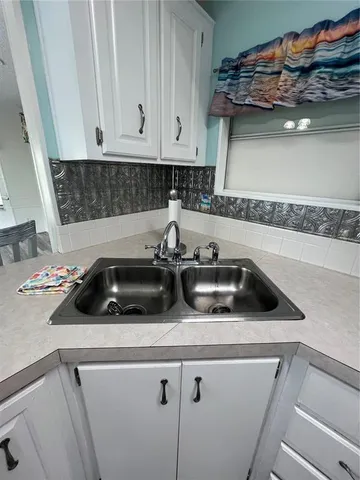 a kitchen with a sink a stove and cabinets