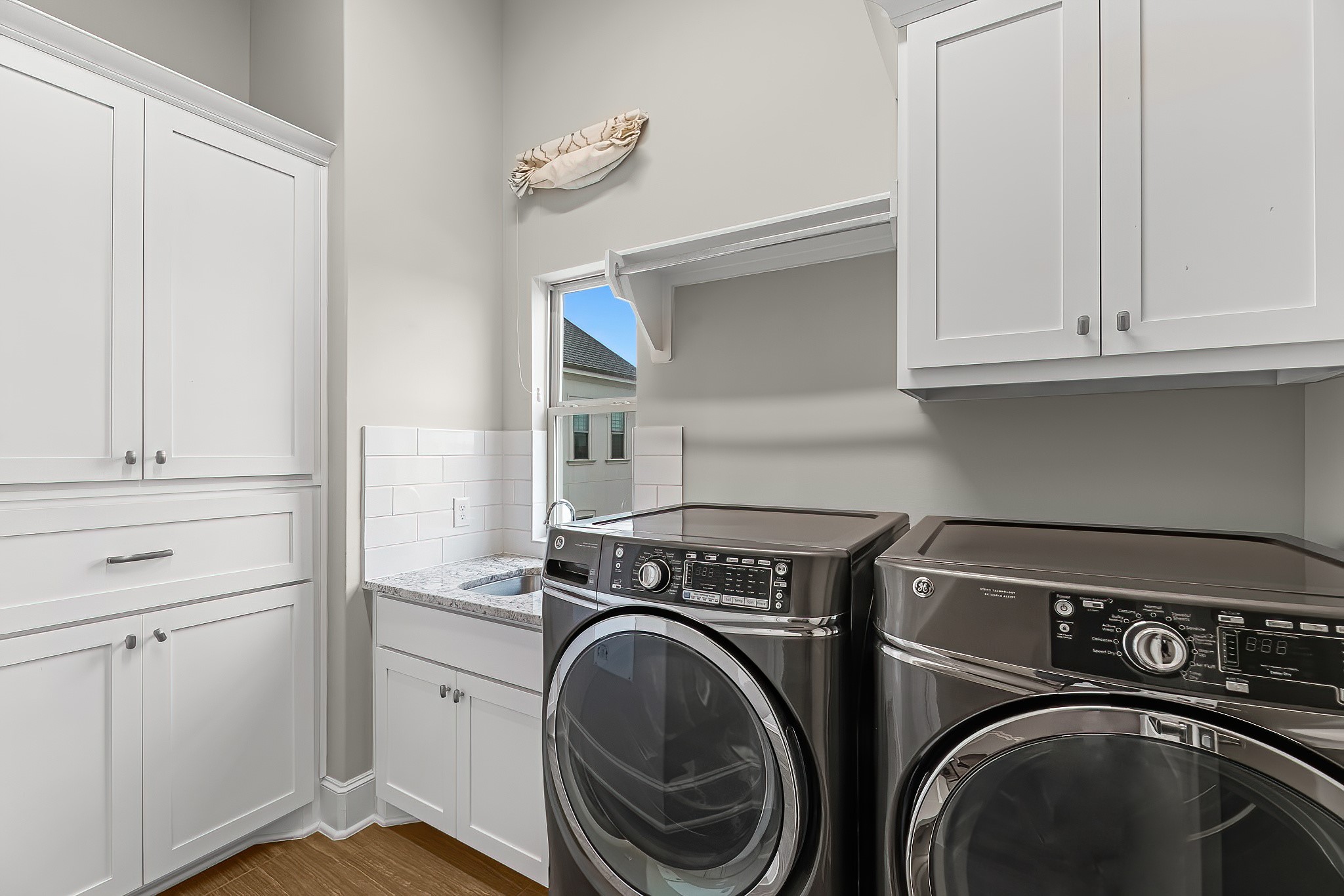 3709 Somerset Commons Lane Houston, TX 77055 - Photo 22 of 32 a utility room with dryer washer and a view of kitchen appliances