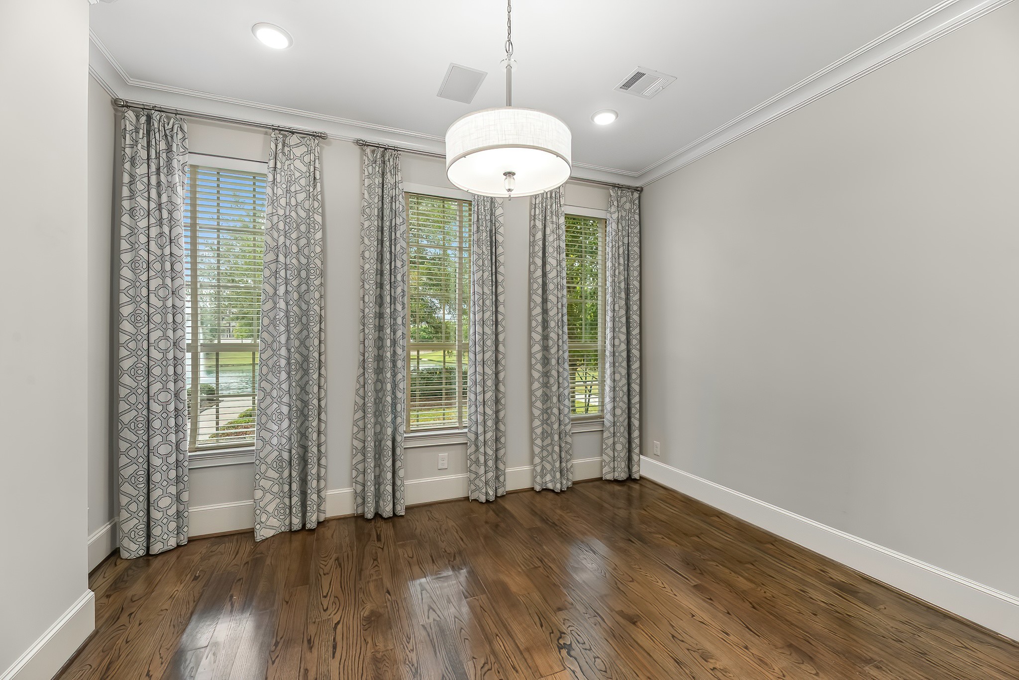 3709 Somerset Commons Lane Houston, TX 77055 - Photo 5 of 32 an empty room with wooden floor and windows