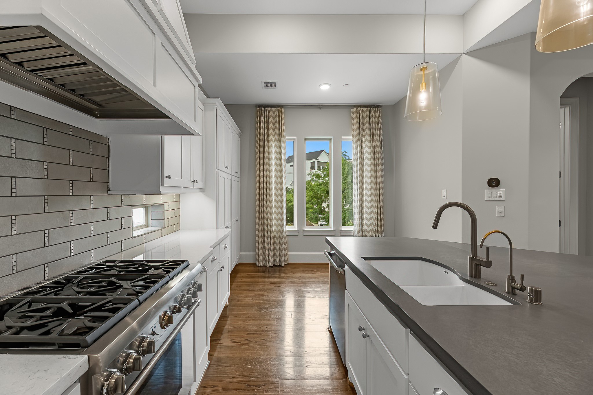 3709 Somerset Commons Lane Houston, TX 77055 - Photo 9 of 32 a kitchen with sink a stove and a window