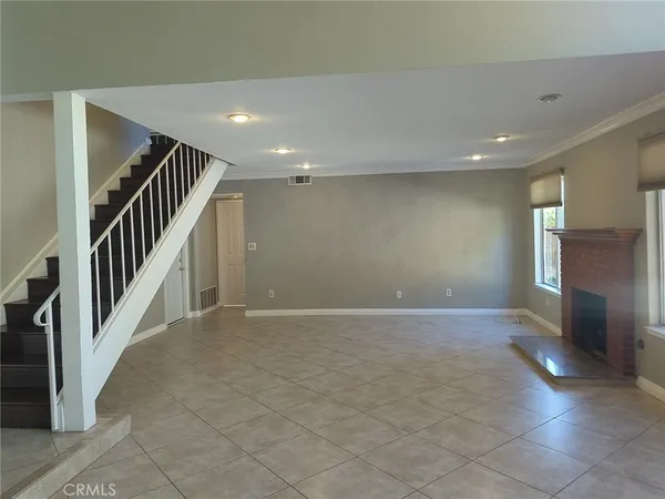 an empty room with windows and stairs