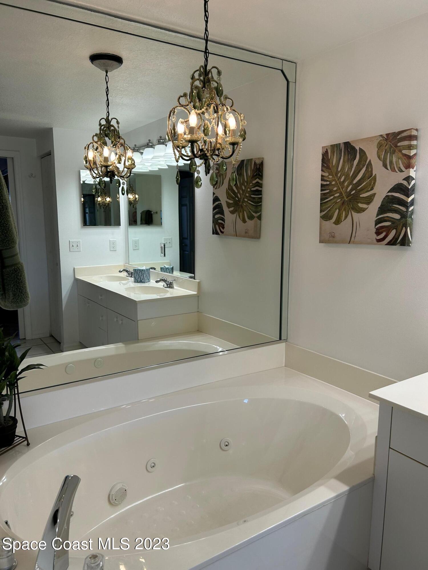 100 Riverside Drive, Unit 403 Cocoa, FL 32922 - Photo 13 of 30 a bathroom with a bathtub sink and mirror