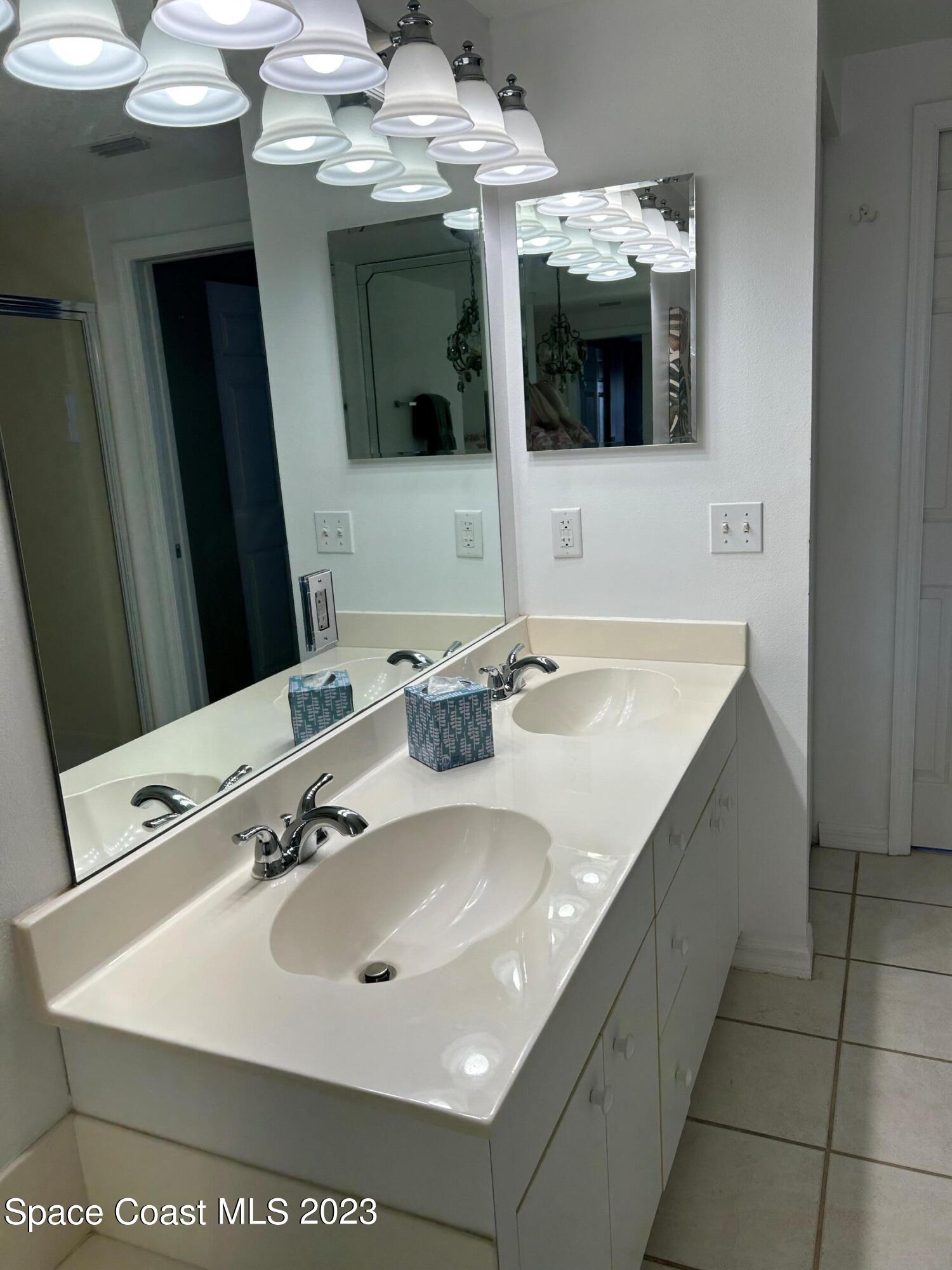 100 Riverside Drive, Unit 403 Cocoa, FL 32922 - Photo 14 of 30 a bathroom with a sink and mirror