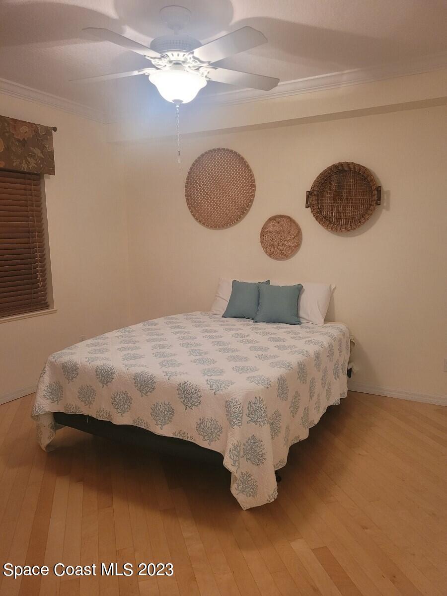 100 Riverside Drive, Unit 403 Cocoa, FL 32922 - Photo 16 of 30 a bedroom with a bed and a painting on the wall