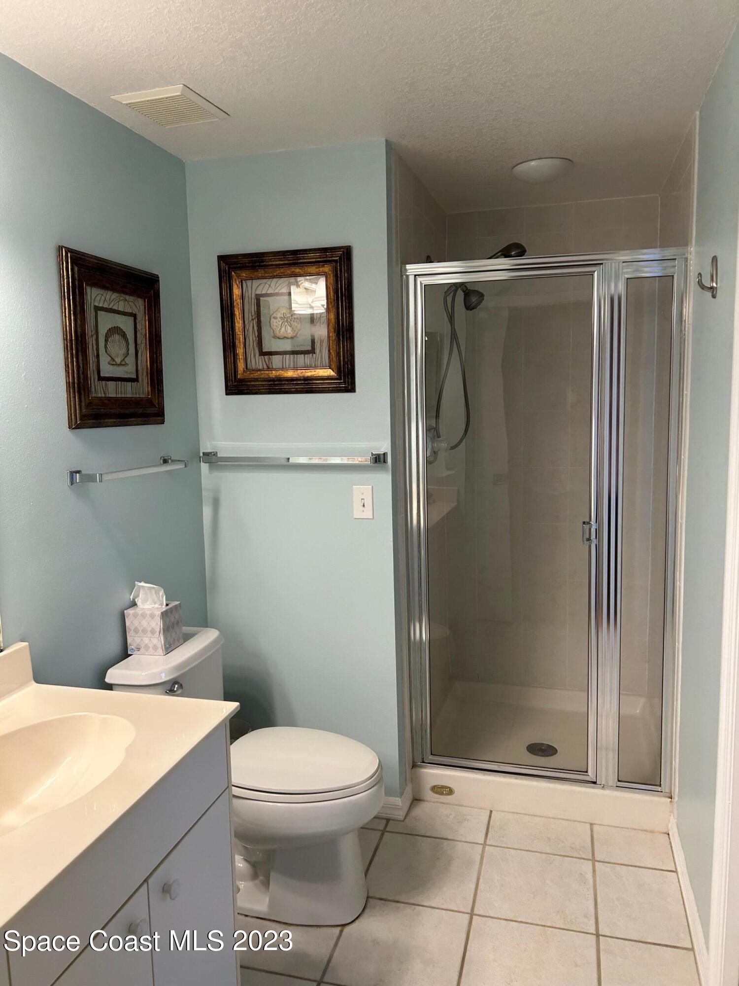 100 Riverside Drive, Unit 403 Cocoa, FL 32922 - Photo 18 of 30 a bathroom with a toilet a sink and shower