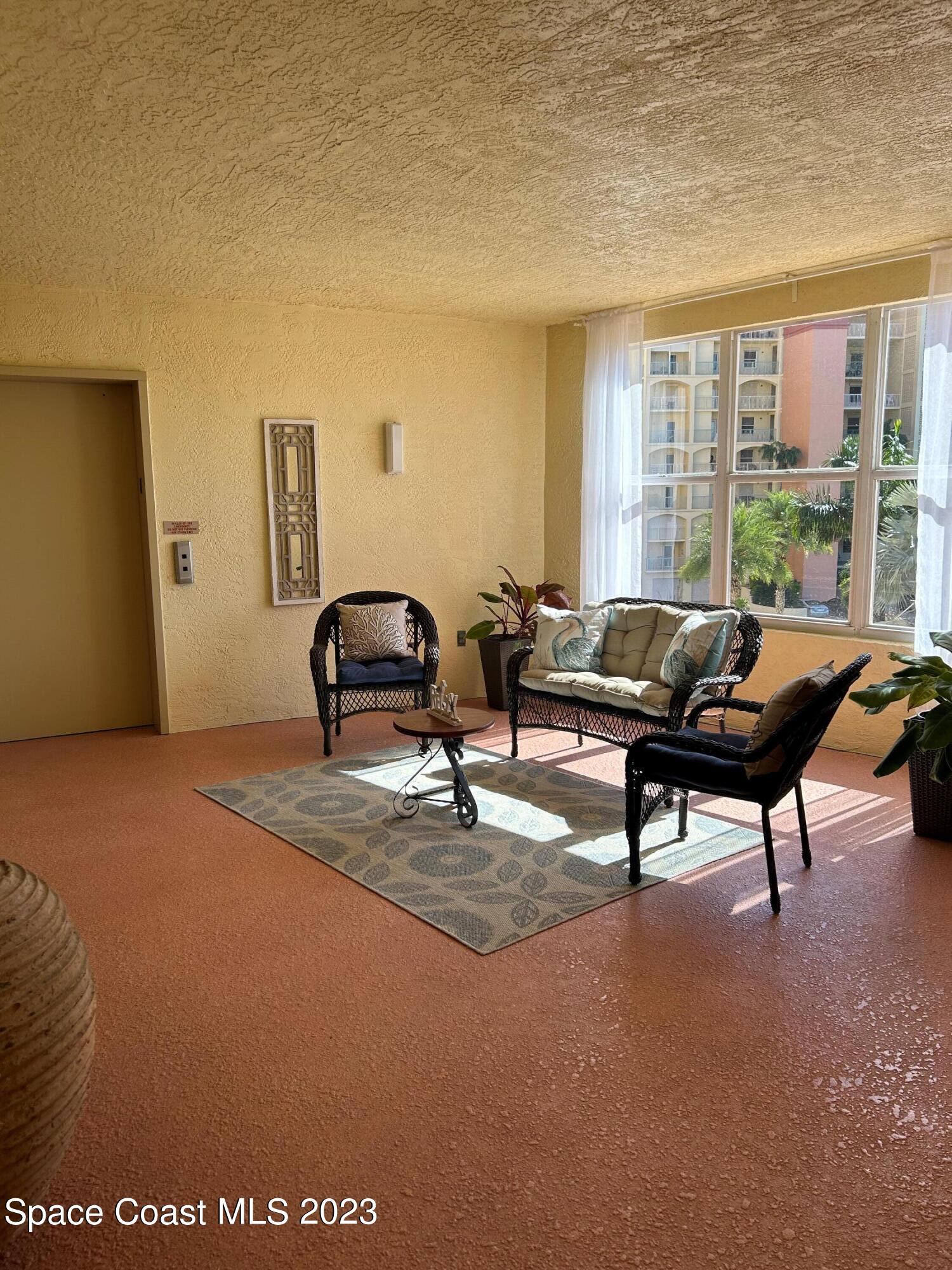 100 Riverside Drive, Unit 403 Cocoa, FL 32922 - Photo 22 of 30 a living room with furniture and a large window
