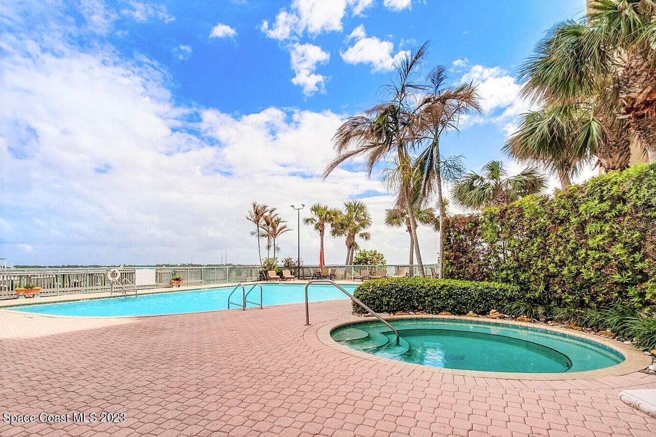 100 Riverside Drive, Unit 403 Cocoa, FL 32922 - Photo 28 of 30 a swimming pool with outdoor seating and yard