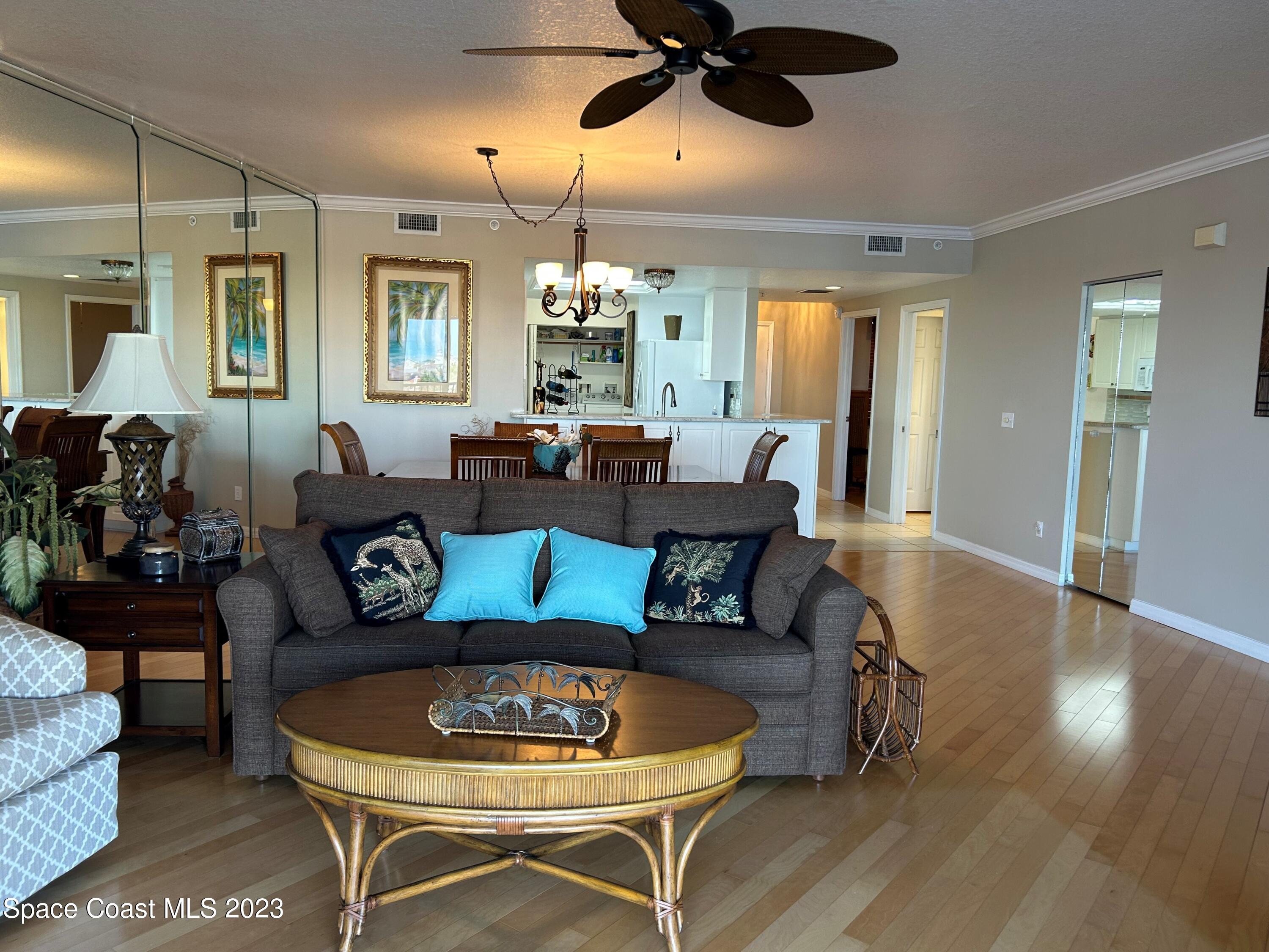 100 Riverside Drive, Unit 403 Cocoa, FL 32922 - Photo 5 of 30 a living room with furniture and a chandelier