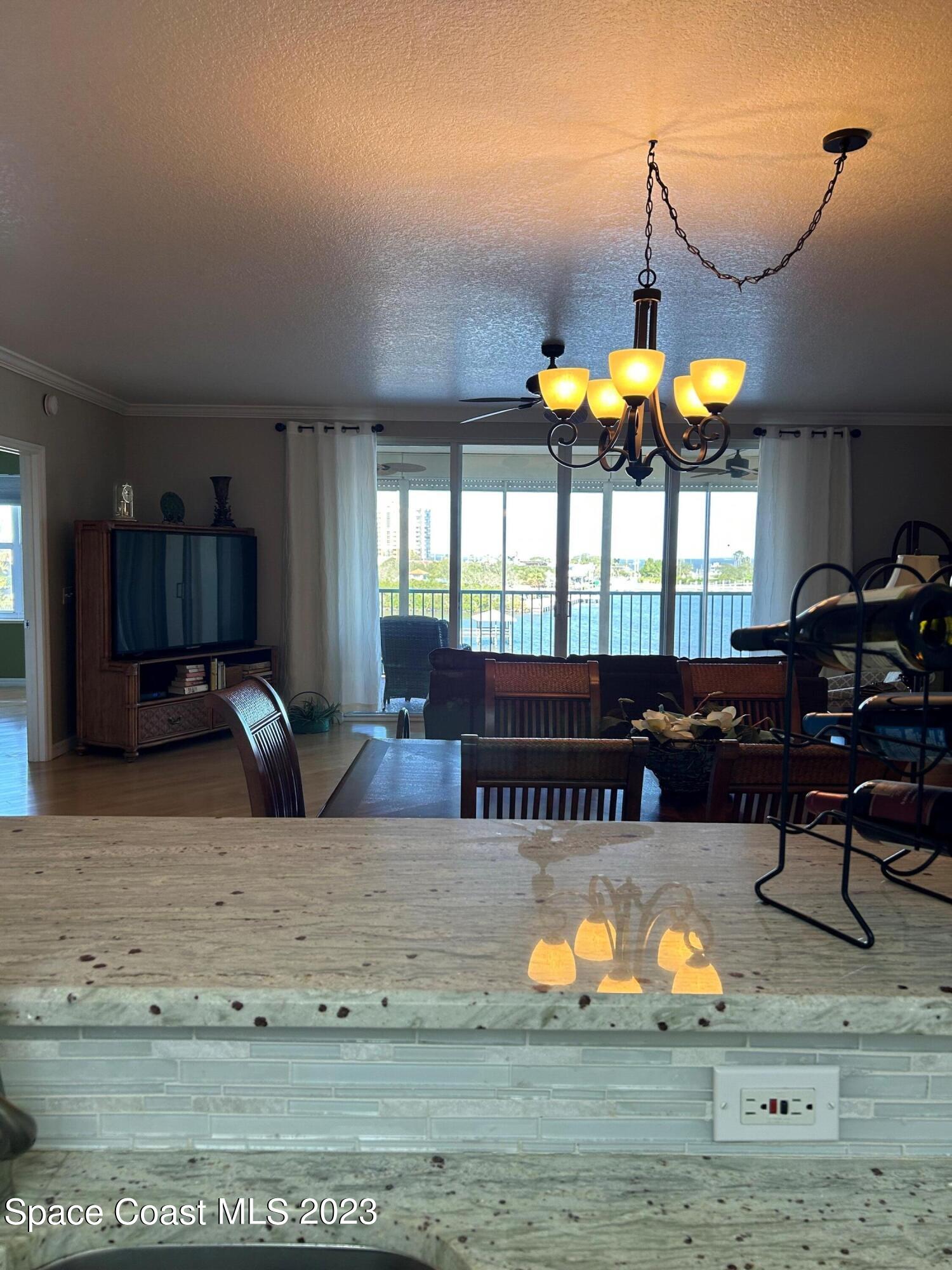100 Riverside Drive, Unit 403 Cocoa, FL 32922 - Photo 10 of 30 a living room with furniture and a large window