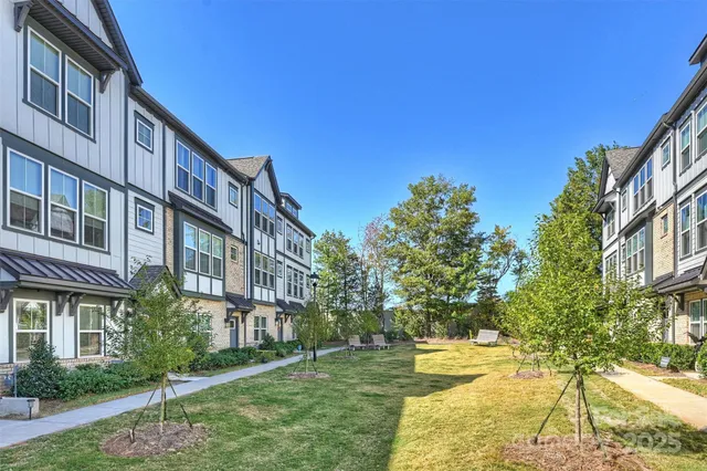 a view of an apartment with a yard