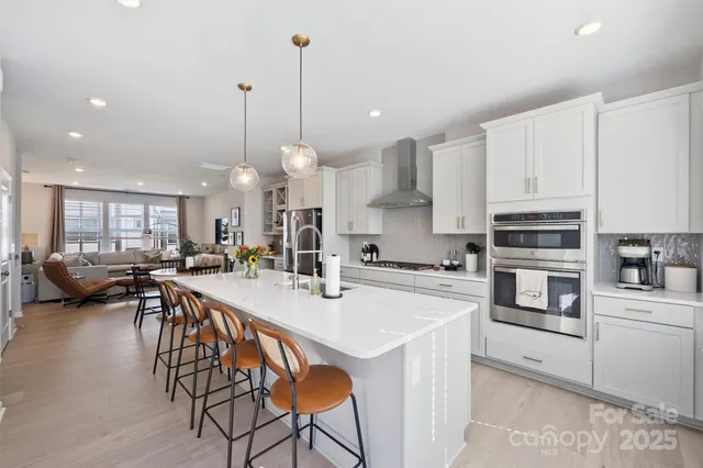 a kitchen with stainless steel appliances kitchen island a large island in the center
