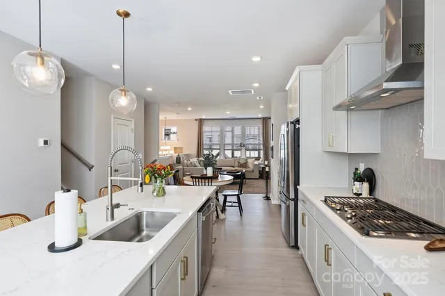 a kitchen with counter top space a sink a stove and refrigerator