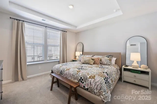 a bedroom with a bed and a large window