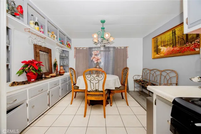 a dining room with furniture and chandelier