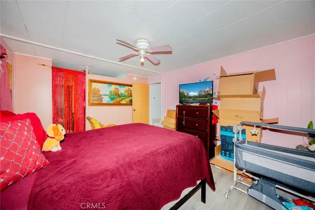 a bed room with a bed and a flat screen tv