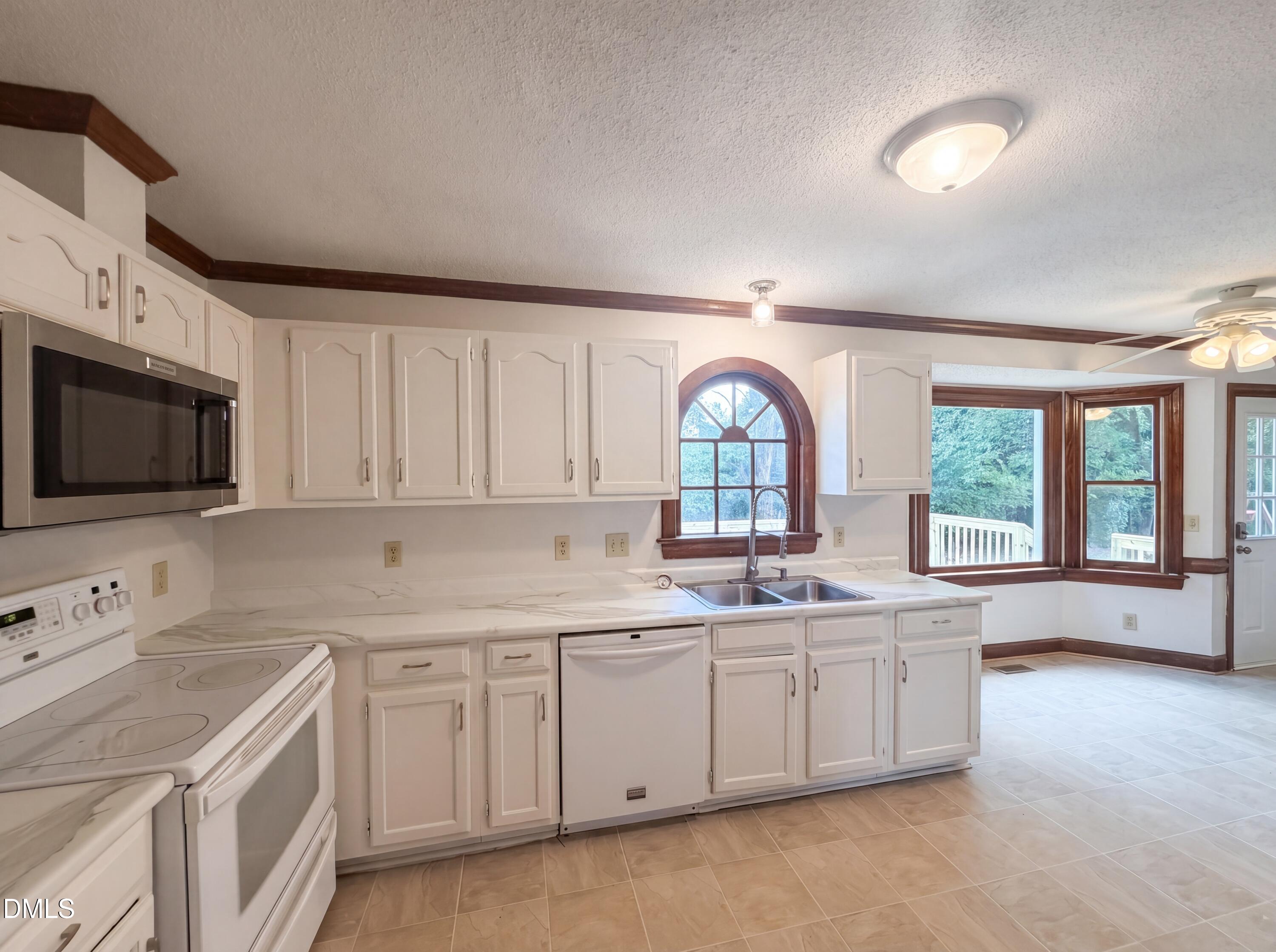 3921 Iron Horse Road Raleigh, NC 27616 - Photo 4 of 20 a kitchen with a sink a stove and cabinets