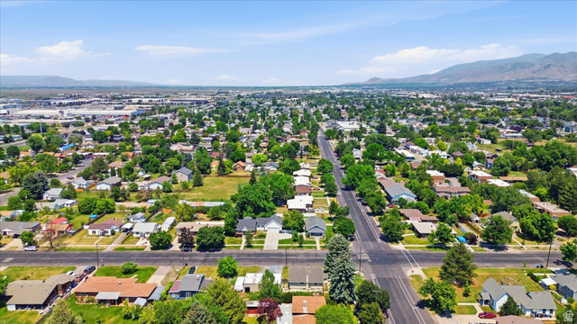 395 North 400 West Logan, UT 84321 - Photo 39 of 48 Aerial perspective showcasing an expansive residential area with scattered mature trees and distant mountain ranges