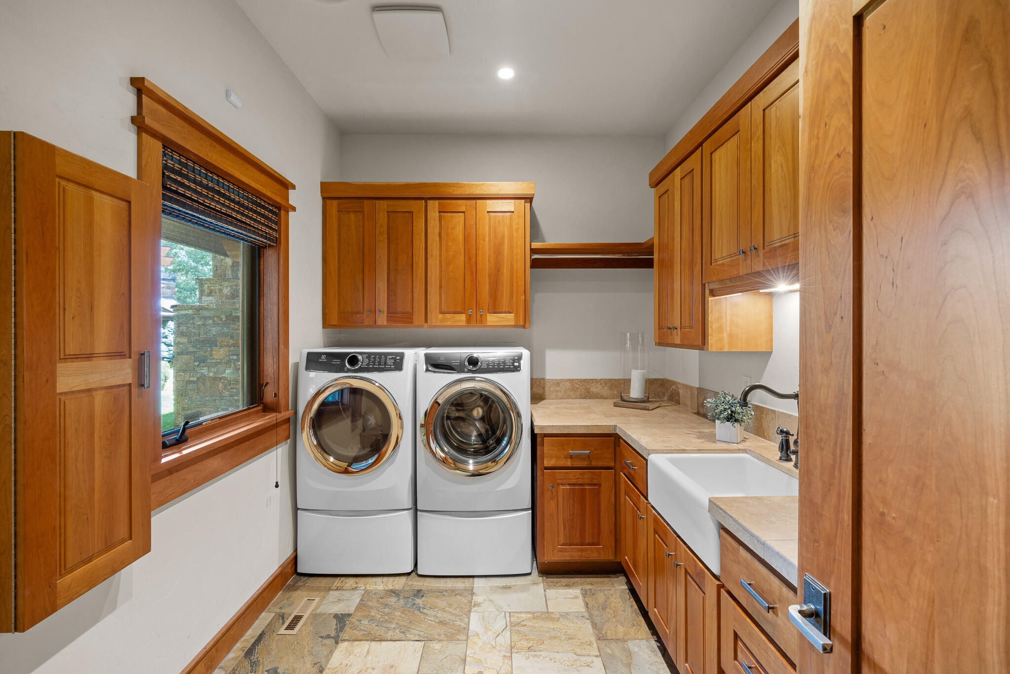 18883 Sutherland Court Bend, OR 97702 - Photo 37 of 70 Spacious laundry room with built-in sink, folding counters, and thoughtful cabinetry.