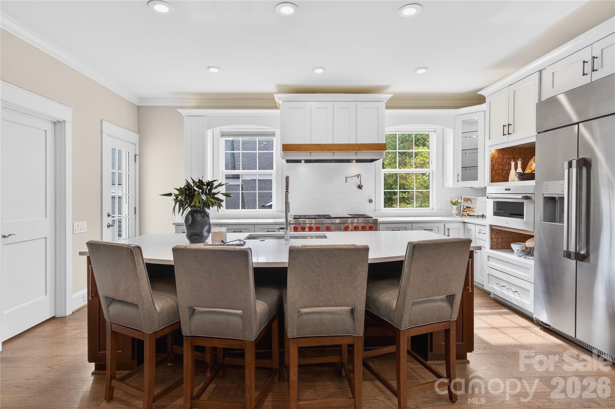 489 South Main Street Davidson, NC 28036 - Photo 12 of 43 a dining room with stainless steel appliances a dining table and chairs