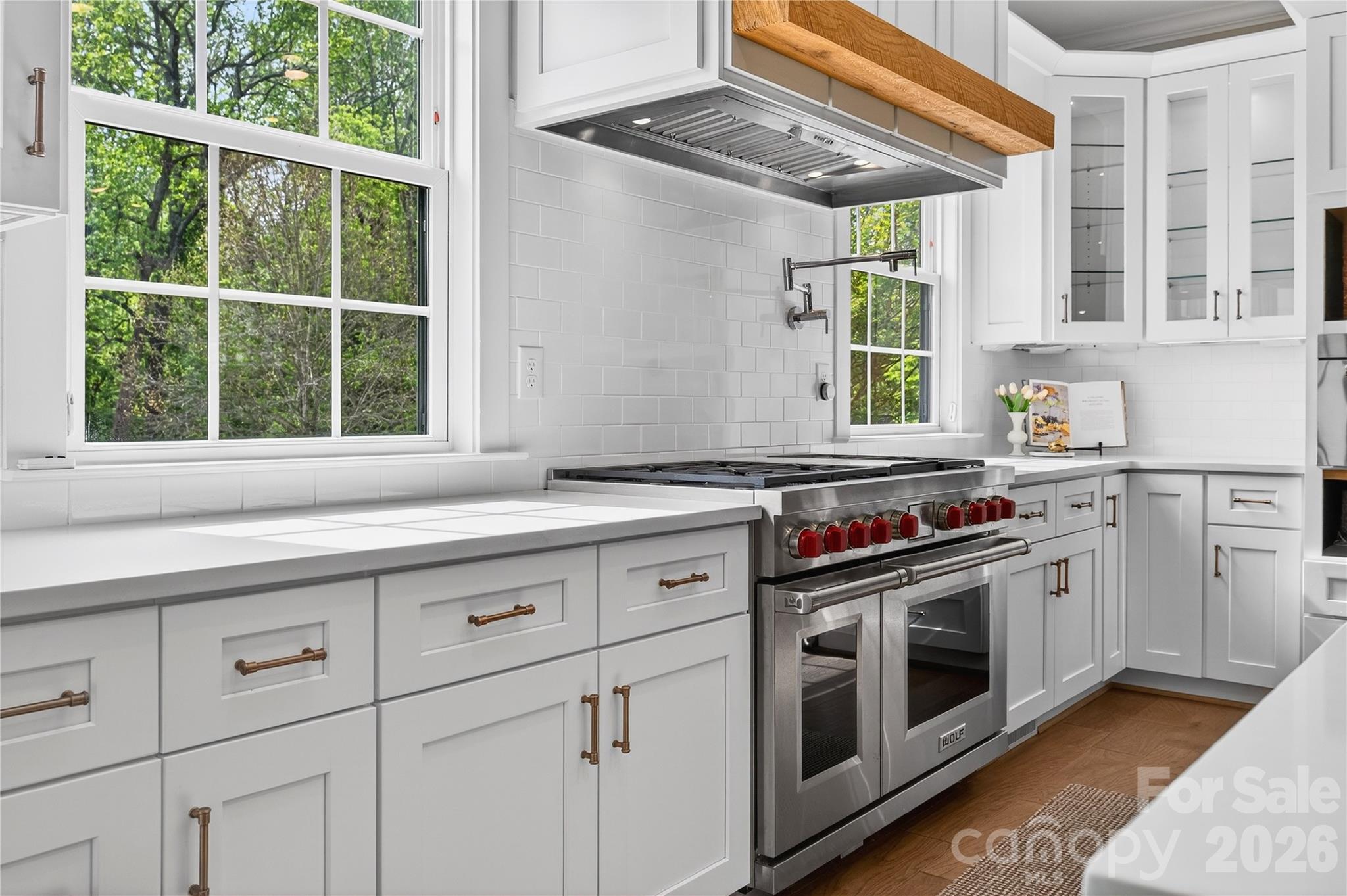 489 South Main Street Davidson, NC 28036 - Photo 13 of 43 a kitchen with stainless steel appliances white cabinets and a window