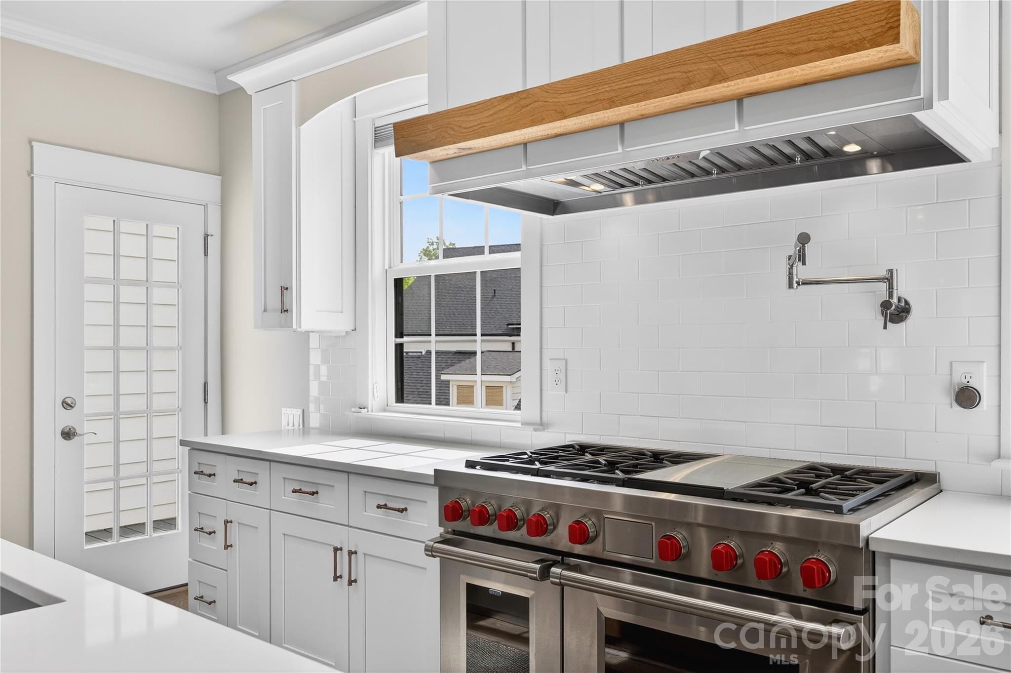 489 South Main Street Davidson, NC 28036 - Photo 14 of 43 a kitchen with a stove and a white cabinets