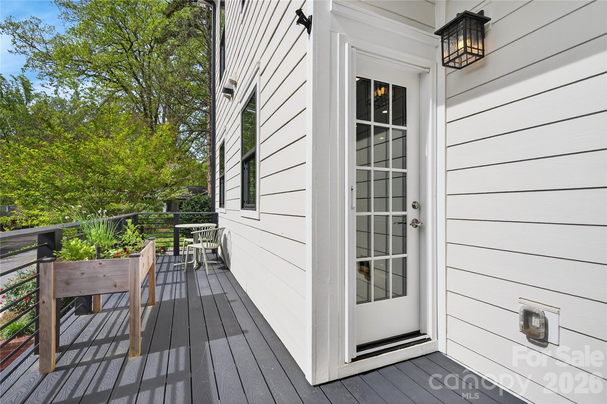 489 South Main Street Davidson, NC 28036 - Photo 15 of 43 a view of balcony with wooden floor and fence and floor to ceiling window