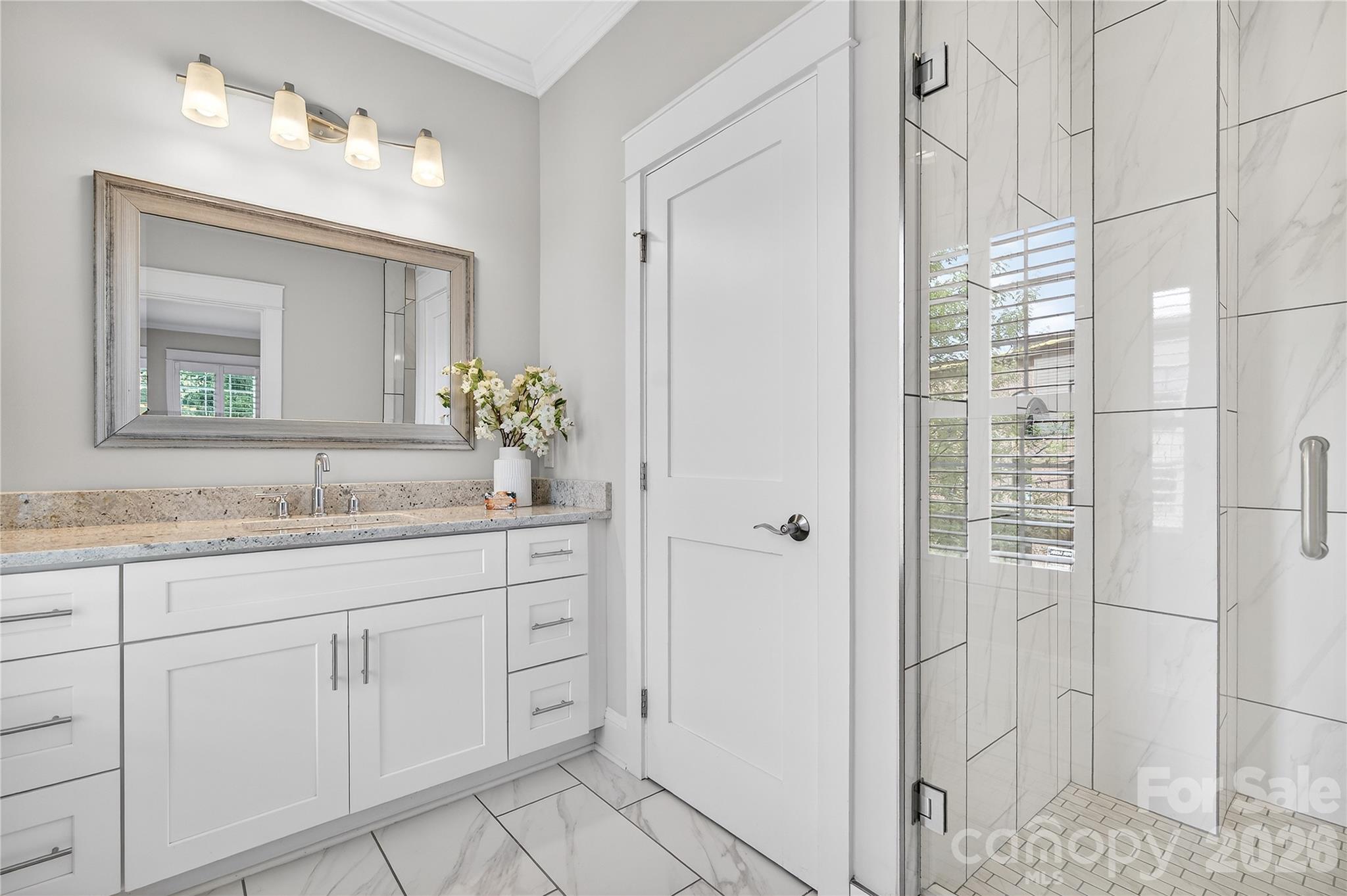 489 South Main Street Davidson, NC 28036 - Photo 29 of 43 a bathroom with a granite countertop sink two mirror and a