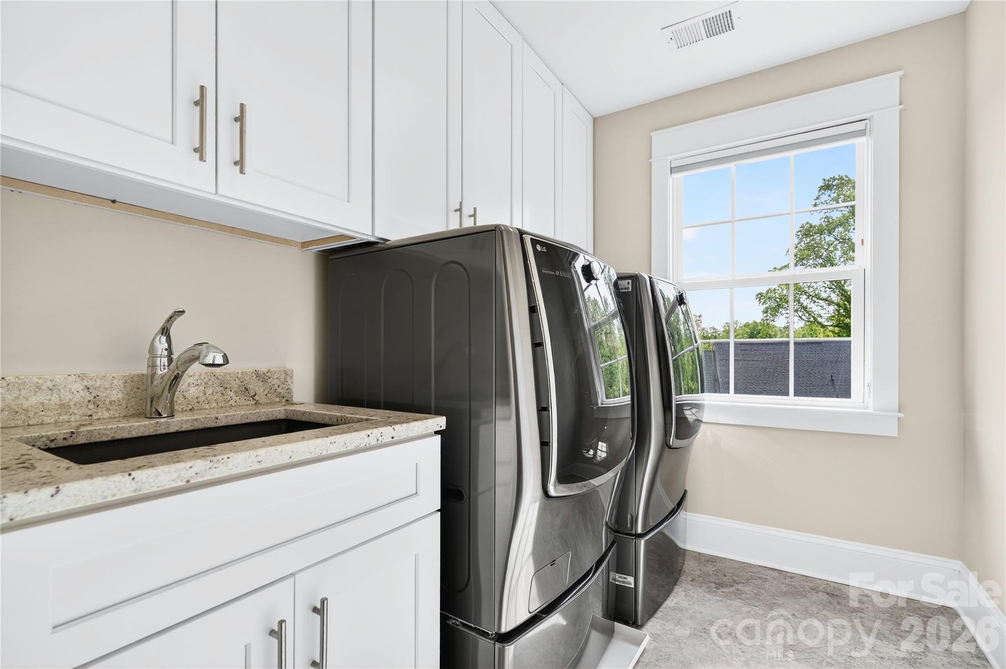 489 South Main Street Davidson, NC 28036 - Photo 36 of 43 a kitchen with stainless steel appliances granite countertop a refrigerator and a sink