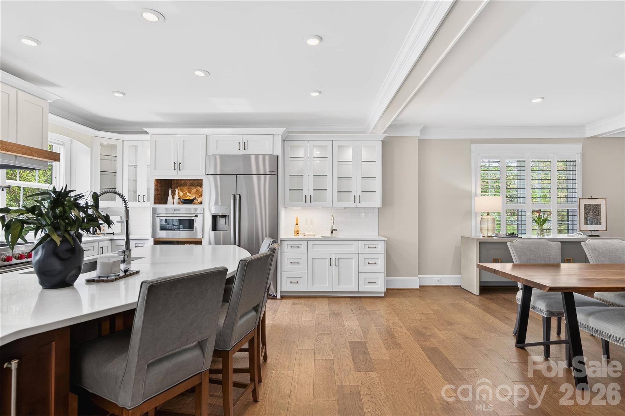 489 South Main Street Davidson, NC 28036 - Photo 8 of 43 a kitchen with a table chairs refrigerator and cabinets
