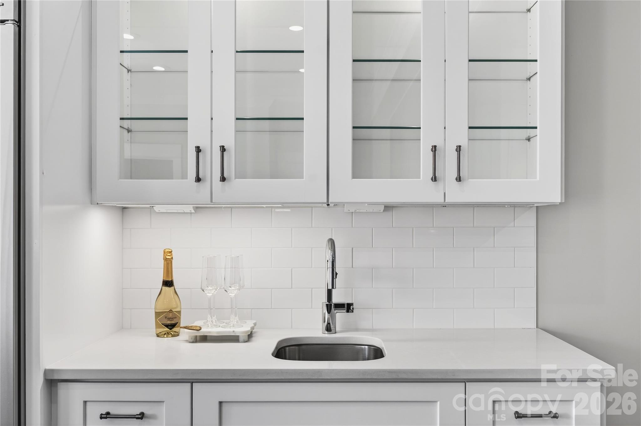 489 South Main Street Davidson, NC 28036 - Photo 9 of 43 a kitchen with white cabinets and a sink