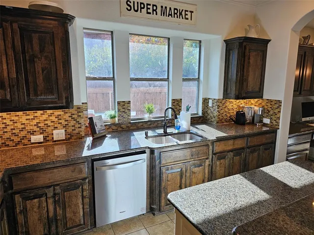a kitchen with a sink stove and refrigerator