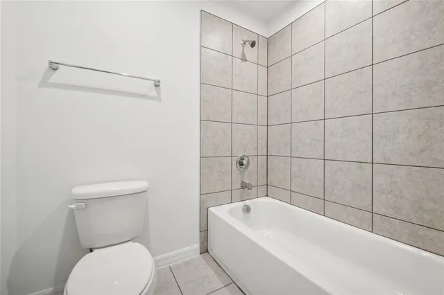 a bathroom with a toilet and bathtub