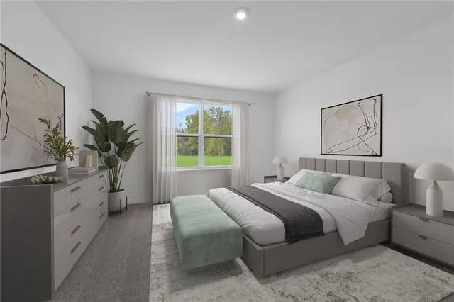 a bedroom with a large bed and a potted plant