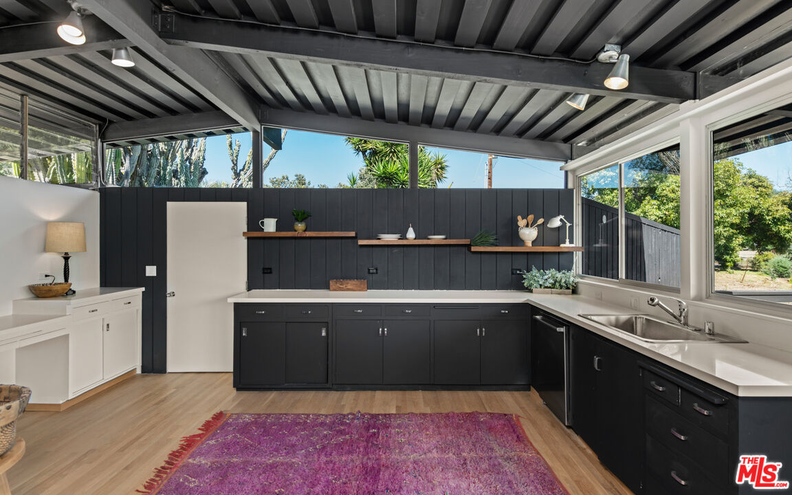 6009 Bonsall Drive Malibu, CA 90265 - Photo 15 of 49 a kitchen with a wooden floor and a sink