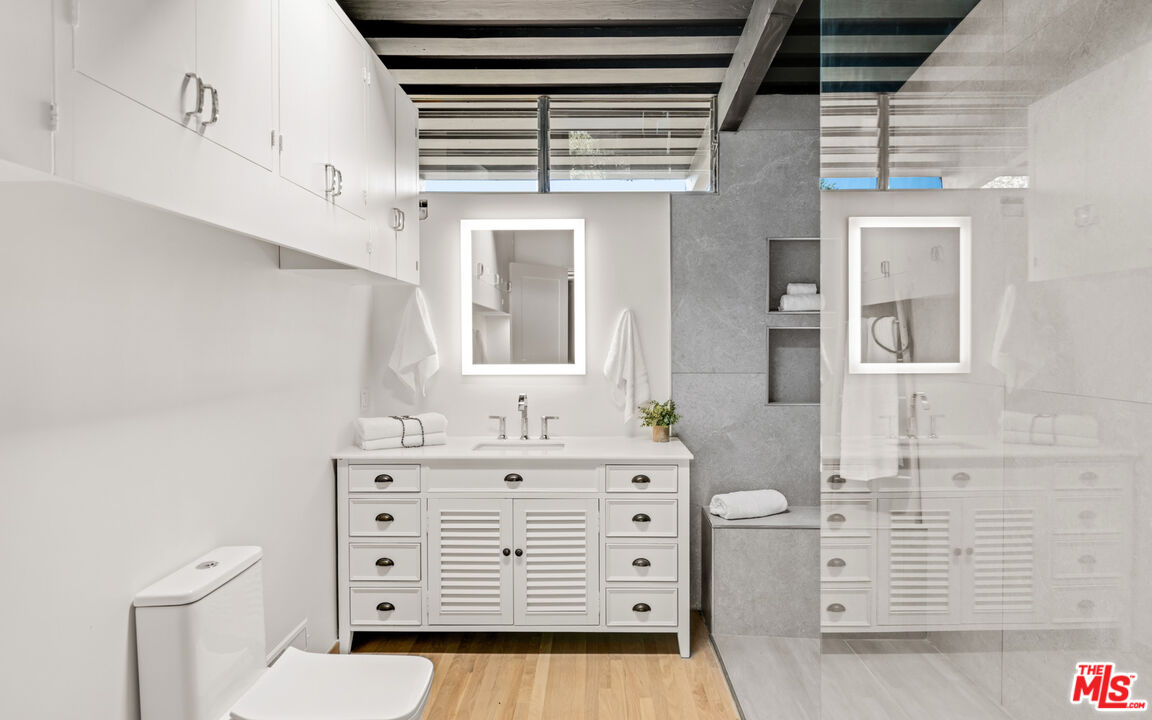 6009 Bonsall Drive Malibu, CA 90265 - Photo 18 of 49 a bathroom with a sink a vanity and a mirror
